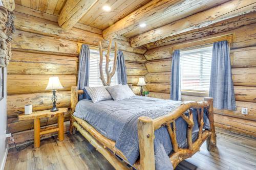 a bedroom with a bed in a log cabin at 'Rustic Cliff Ranch' in Uintah Basin: Dogs Welcome in Fort Duchesne