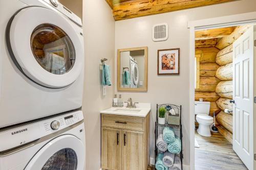 a bathroom with a washer and dryer in a log cabin at 'Rustic Cliff Ranch' in Uintah Basin: Dogs Welcome in Fort Duchesne