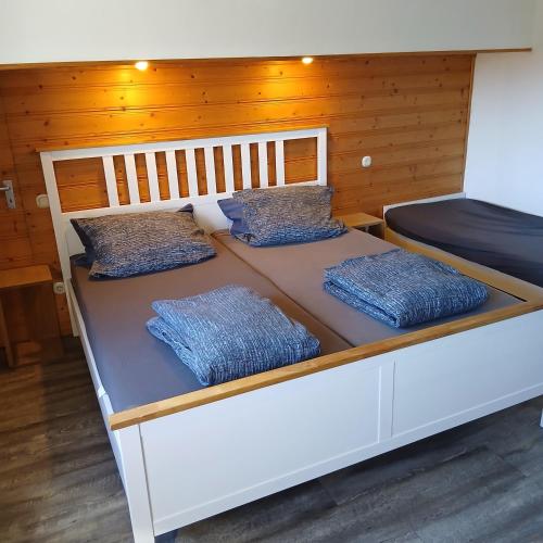 a large bed with two pillows on top of it at Sunrise B&B Hellenthal in Hellenthal