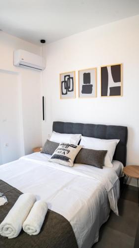 a bedroom with a large bed with white sheets and pillows at Basil Leaf - Minimal View Retreat in Gonia