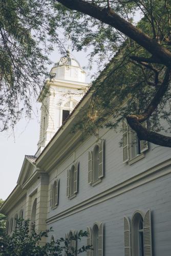 a white building with a tower on top of it at Hotel del Parque in Guayaquil