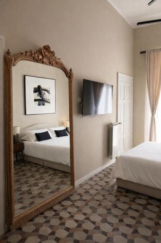 a large mirror in a bedroom with two beds at Bari LandLord 71 - Private Balcony Suites in Bari