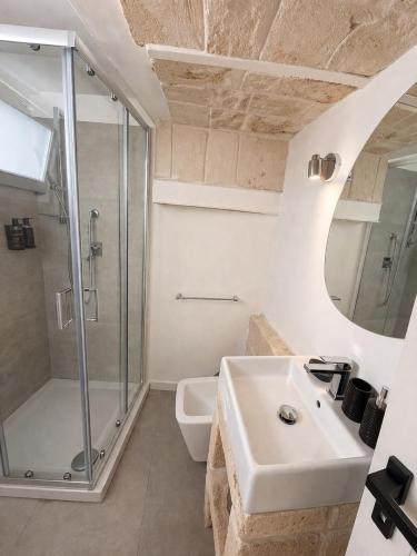 a bathroom with a sink and a shower at Bari LandLord 71 - Private Balcony Suites in Bari