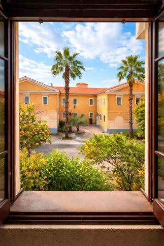 an open window with a view of palm trees at Mediterranean Rooms Koper in Koper