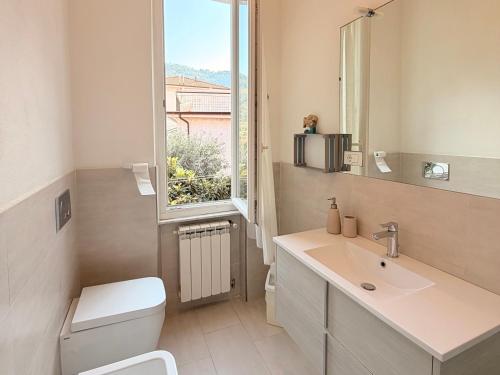 a bathroom with a toilet and a sink and a window at Terrazza Portovenere in Le Grazie