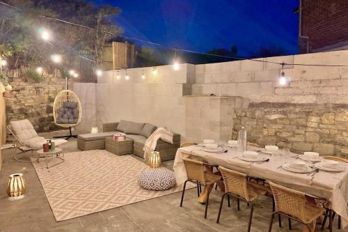 a patio with a table and chairs and a couch at Shrubbery Lodge - Games Room & Patio Dining in Wyke Regis