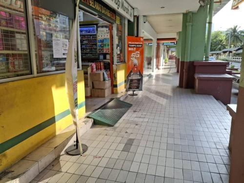 an empty aisle of a store with a broom at BlackView in Kota Kinabalu
