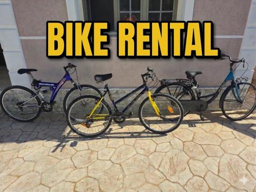 three bikes parked in front of a building at Rent rooms Loren in Vlorë