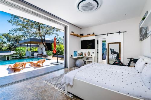a bedroom with a bed and a pool at La Villetta in Ostional