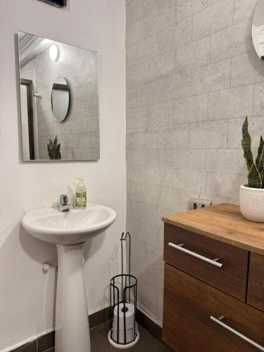 a bathroom with a sink and a mirror at Casa Ligia in Medellín