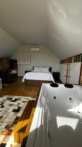 a bedroom with a bed and a bath tub at cabana refúgio in Paulo Lopes