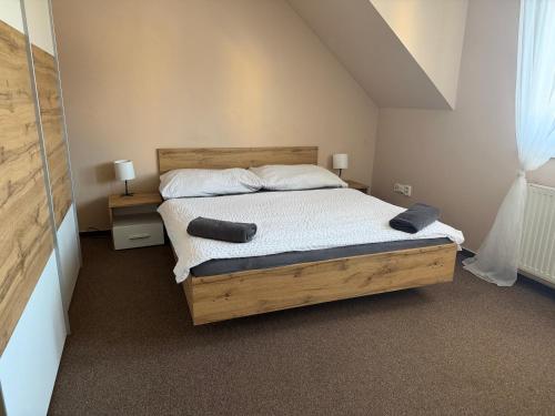 a bedroom with a bed with two pillows on it at Penzion U Růže in Sezimovo Ústí
