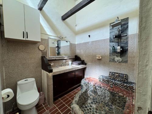 a bathroom with a toilet and a sink at Baja Beach House Pools, Beaches & Ocean View in San Antonio del Mar