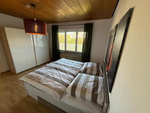 a bedroom with a bed and a window in it at Chalet Annemie in Mendig