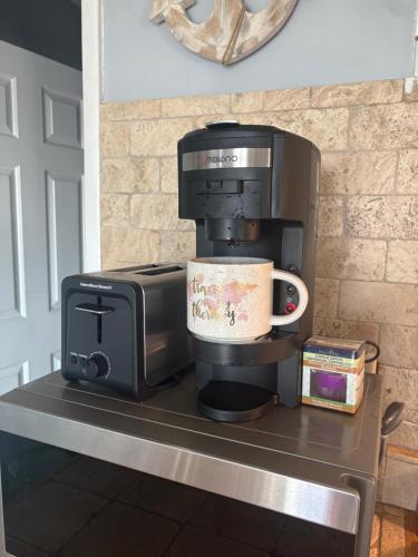 a coffee maker and a microwave on a counter at Stay beachy in Gulf Shores
