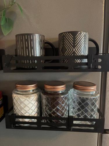 a shelf with jars and cups on it at Stay beachy in Gulf Shores