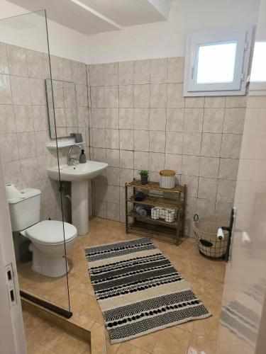 a bathroom with a toilet and a sink at Reborn Project Plakes in Skiathos