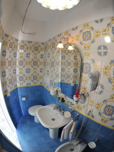 a bathroom with a sink and a toilet at Locanda Costa D'Amalfi in Amalfi