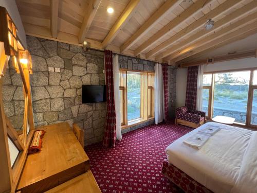 a hotel room with a bed and a tv at Montvale Resort in Pasu