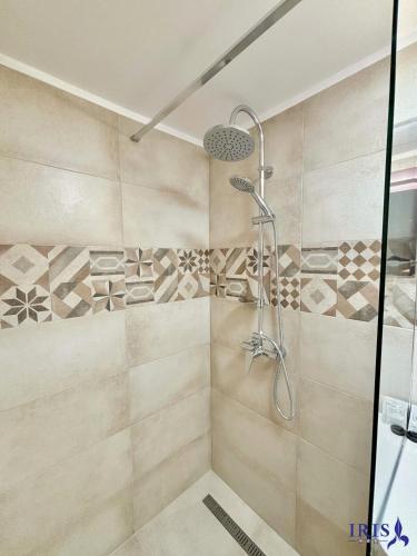 a shower with a glass door in a bathroom at Pensiunea Iris in Băile Tuşnad