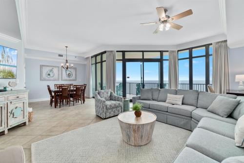a living room with a couch and a table at Phoenix West 2207 Upscale Luxury Updated Beachfront Waterslide-Lazy River in Orange Beach