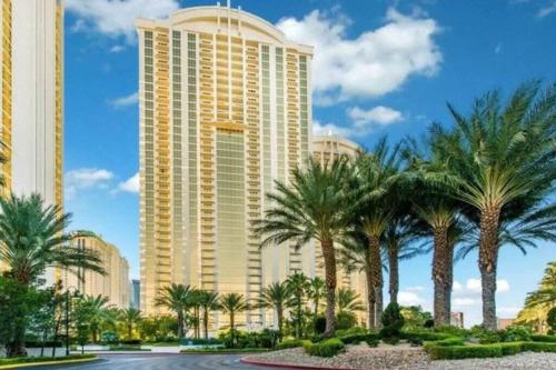 a large building with palm trees in front of it at The Signature MGM Las Vegas in Las Vegas
