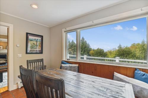 a dining room with a table and chairs and a large window at Mill Lane in Stowe