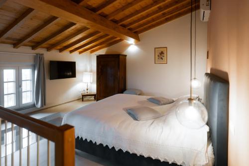 a bedroom with a large bed in a room with wooden ceilings at L'oasi di Renata in Lammari