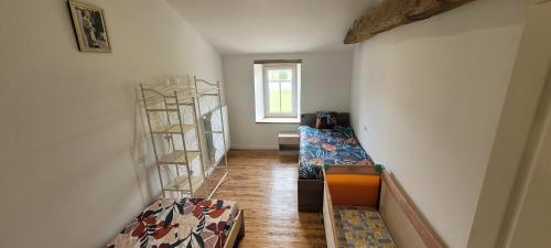 a room with a staircase with a couch and shelves at rêve d'escapade in Mouilleron-en-Pareds