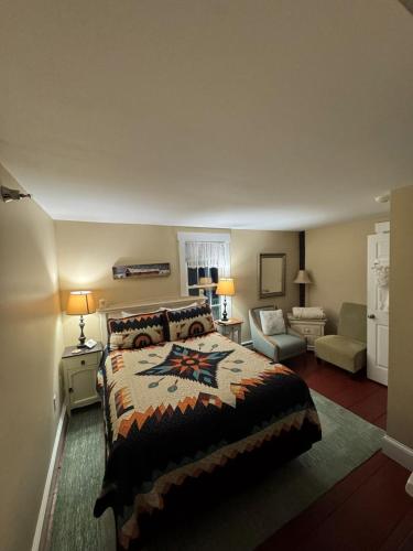 a bedroom with a bed and a living room at Ballard House Inn in Meredith