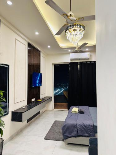 a bedroom with a bed and a ceiling fan at The Skyline Studios in Ghaziabad