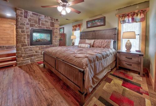 a bedroom with a large bed and a stone wall at Break Time in Gatlinburg