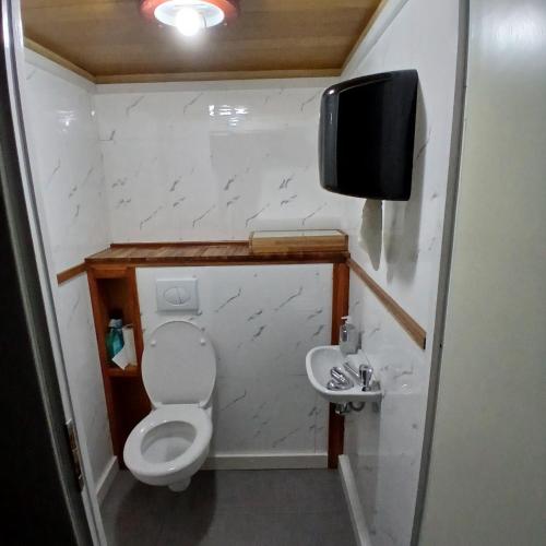 a small bathroom with a toilet and a sink at Sunrise B&B Hellenthal in Hellenthal