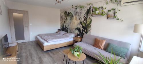 a living room with a couch and a bed at Baross apartman in Kaposvár