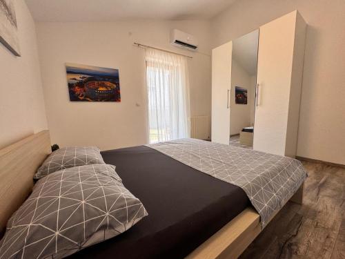 a bedroom with a large bed in a room at Apartment olive tree garden&poll view 4 plus 2, 130 m2 with tiki bar in Peroj
