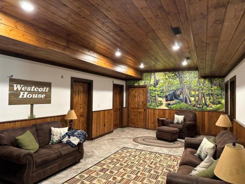 a living room with couches and a large mural at Westcott House- Privacy, amenities and space all in one beautiful package! in Luray