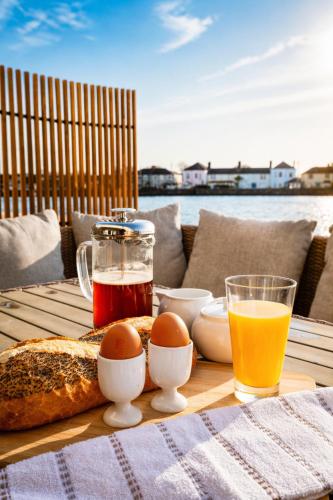 a table with eggs and bread and a glass of orange juice at Dog-friendly Seaview Apartment in Dungarvan