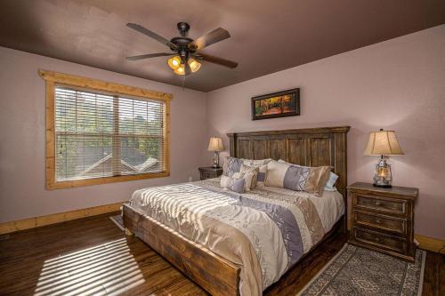a bedroom with a bed and a ceiling fan at Hilltop Haven in Gatlinburg