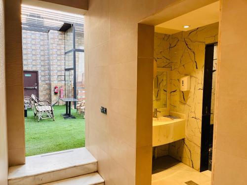 a bathroom with a sink and a large window at فندق ليان بارك Lian Park Hotel in Al Khobar
