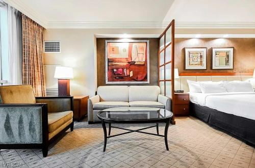 a hotel room with a bed and a coffee table at The Signature MGM Las Vegas in Las Vegas