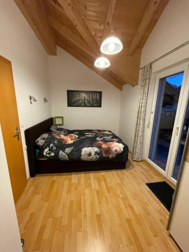 a bedroom with a bed and a wooden floor at Villa Sonnenblick in Kötschach