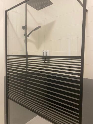 a shower stall with a shower head in a bathroom at Porta 28 in Quinta do Anjo