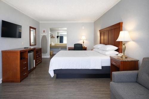 a hotel room with a large bed and a couch at Quarters Inn & Suites in Antioch