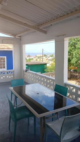 a table and chairs on a porch with a view of the ocean at Dushi Boca Sami in Dorp Sint Michiel