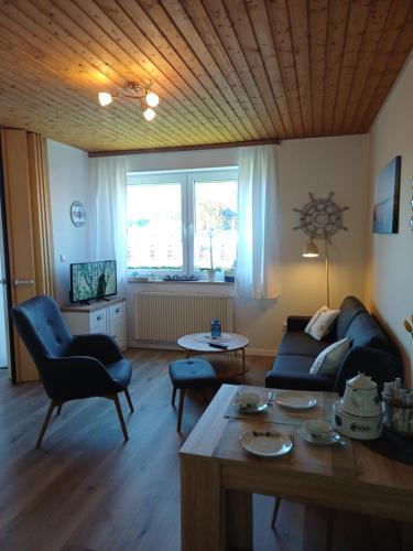 a living room with a couch and a table at Sielpferdchen Bensersiel in Bensersiel