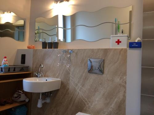 a bathroom with a sink and a mirror at Apartament Nad Galerią in Stargard