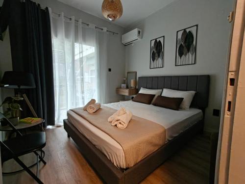a bedroom with a bed with two towels on it at house blue sea in Iraklitsa