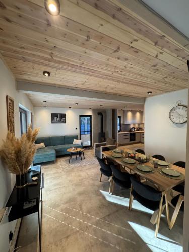 a large living room with a table and a couch at Wooden House Kaszuby in Borsk