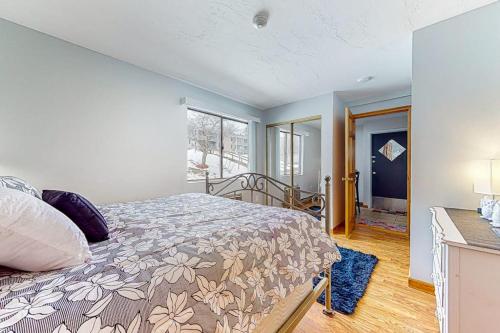 a bedroom with a bed and a large window at Lakeside Delight, unit 423 in Laconia