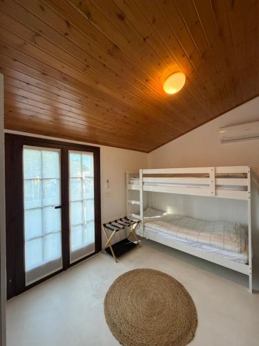a room with two bunk beds and a rug at Villa Vittoria in Lignano Sabbiadoro